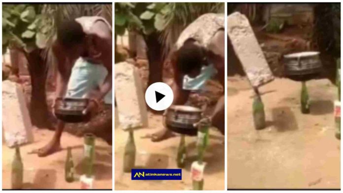 Man suspends a brick and pot on a bottle