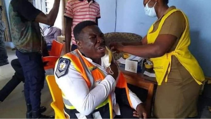A police officer in tears as he takes the covid-19 vaccines.