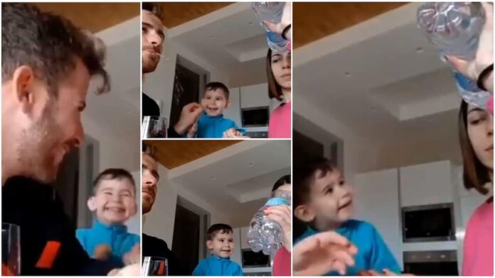 parents performing 'magic' with water to make their little kid laugh