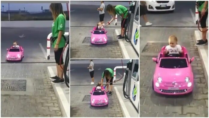 baby drives toy car to fuel station
