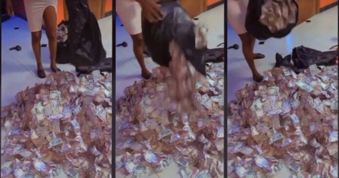 Lady shows off the heaps of money she picked at Obi Cubana’s mother’s funeral
