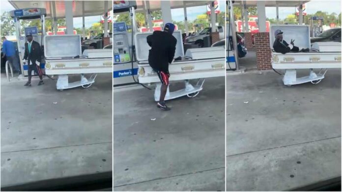 Man spotted fueling up motorized coffin car in a filling Station