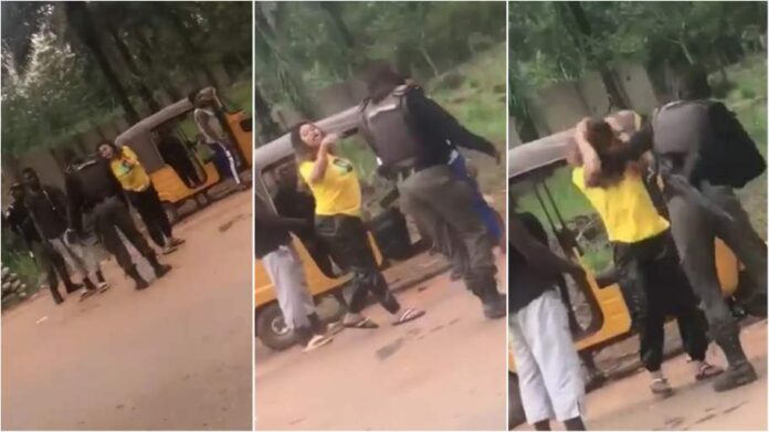 Police officer caught on camera beating young lady at checkpoint in Enugu