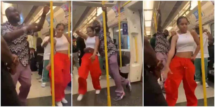 Davido dancing with an unknown lady in a moving train