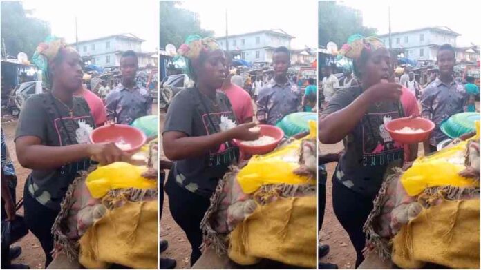 Lady selling rice dips her hands in the food before serving customers