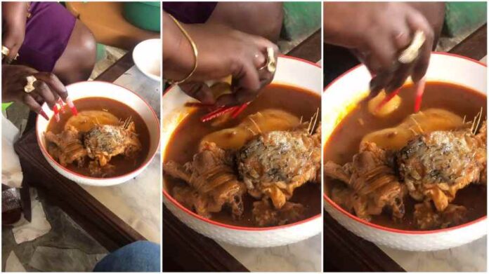 Lady struggles to eat fufu with long attached nails