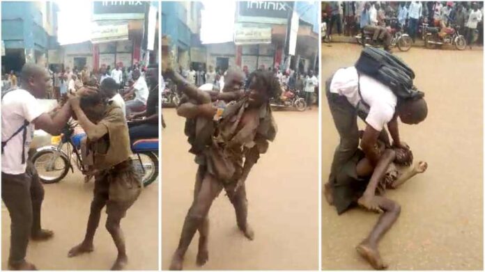 Pastor roughs up mad man on street as her deliver him from spirit of madness