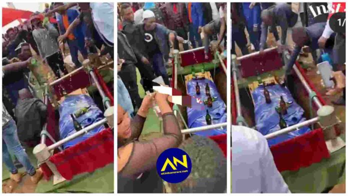 Friends of the dead bathe a coffin with alcohol