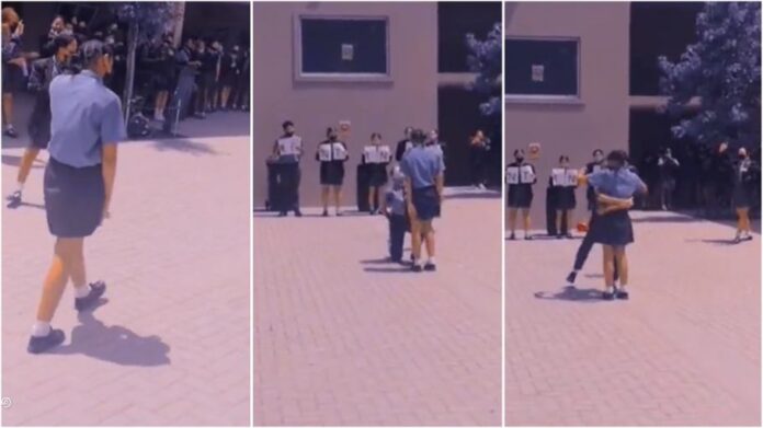 Female secondary student goes on her knees to propose to another female student