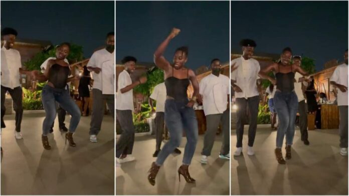 Lady in heels leads men in dance lesson with intense energy
